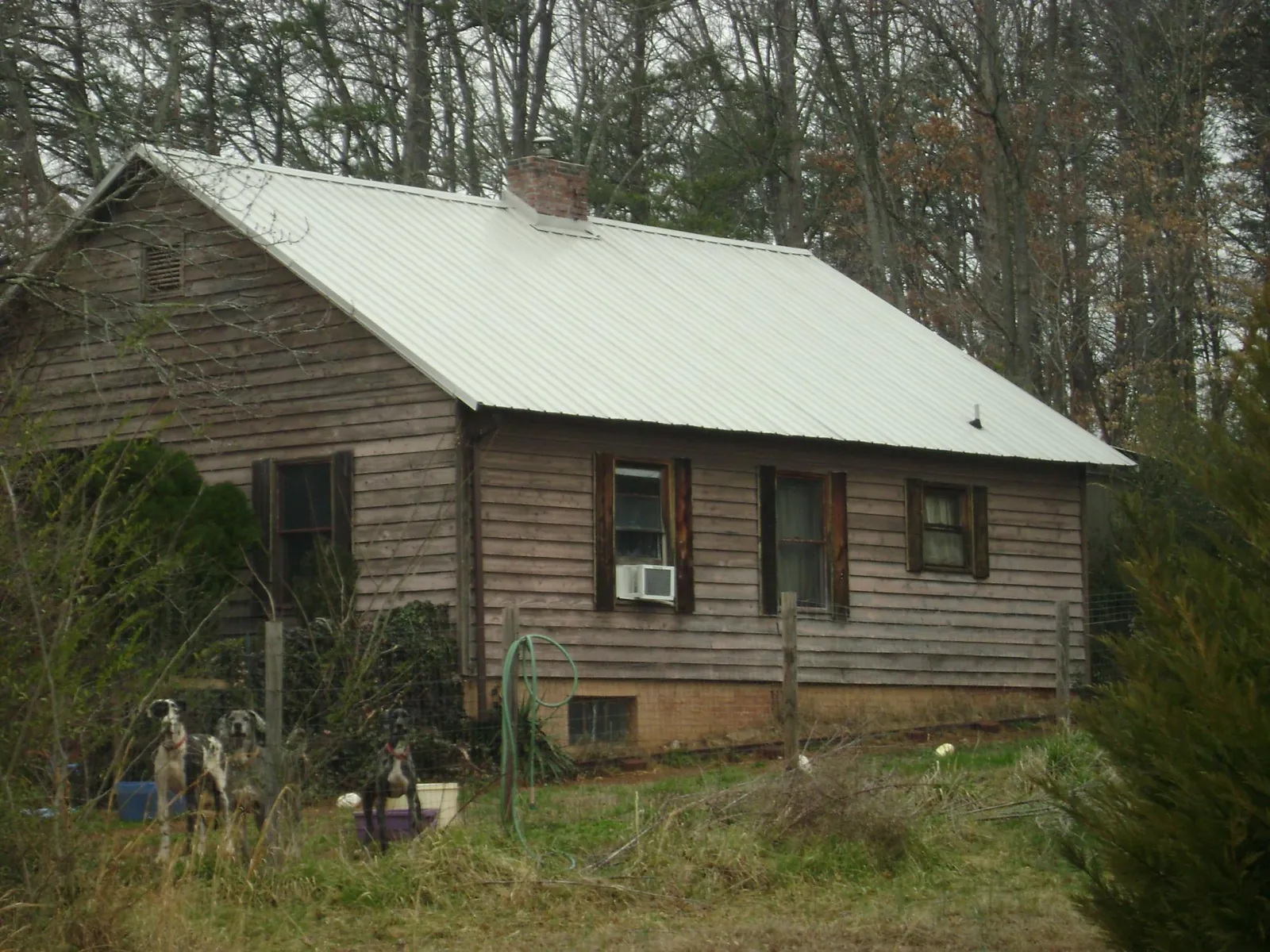 White metal roof on an old wood sided farmhouse, from a Metal Roof Installation job in Kahului